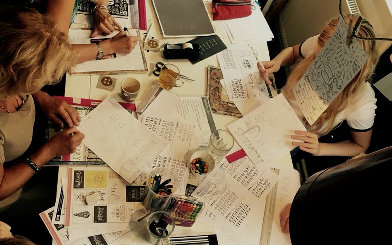 A group working around a table covered in plans
